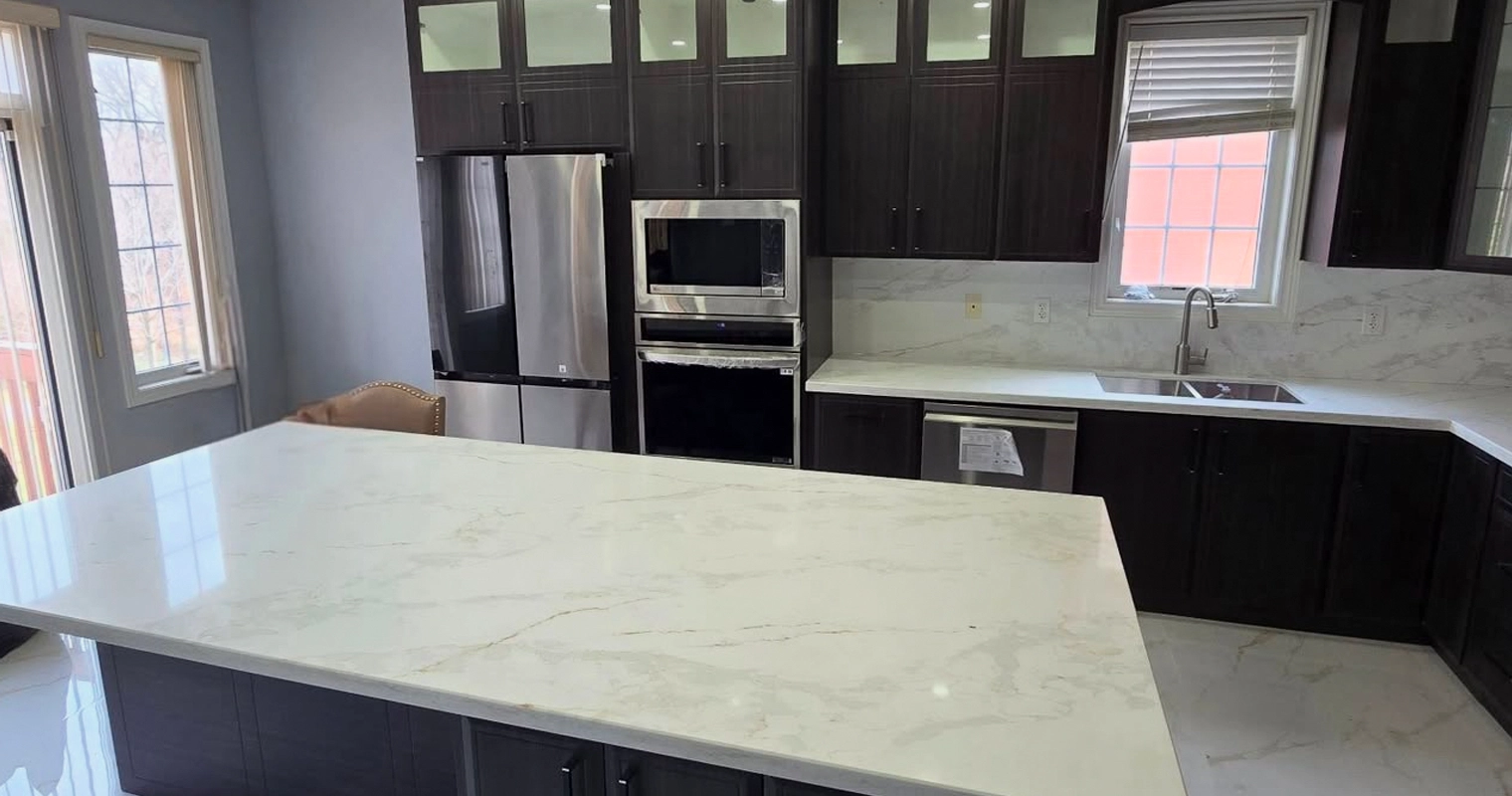 A dark cabinets with white and gray countertop kitchen renovation project completed by Titan Cabinetry