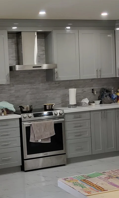 A grey and white kitchen renovation project completed by Titan Cabinetry