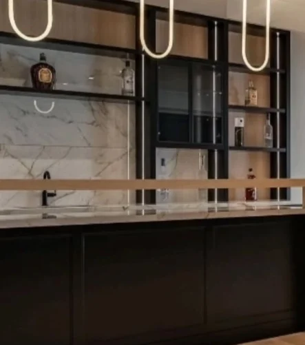 A luxurious black and wood accent bar installed by Titan Cabinetry