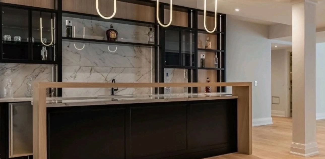 A luxurious black and wood accent bar installed by Titan Cabinetry